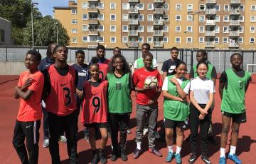 Two football teams of young adults wearing vests